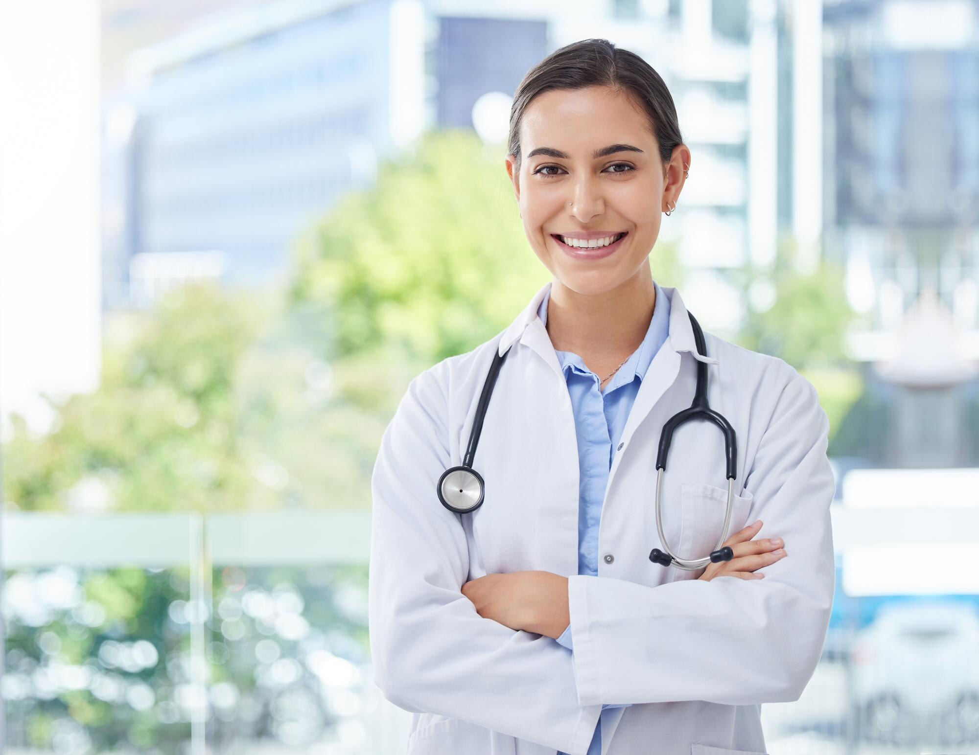 Confident female doctor wearing a white coat and stethoscope, representing MRCP Part 2 March 2026 exam preparation and clinical readiness.